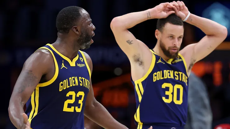 Draymond Green #23 and Stephen Curry #30 of the Golden State Warriors display frustration with a foul call during the second half of a game against the Los Angeles Lakers at Crypto.com Arena.