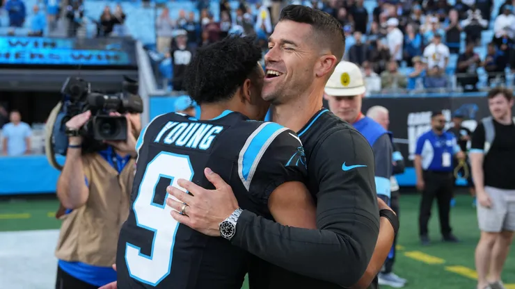 Dave Canales and Bryce Young of the Carolina Panthers embrace after a win.