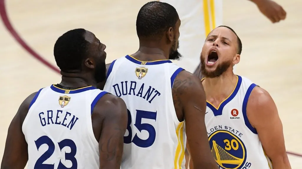Stephen Curry #30 and Draymond Green #23 of the Golden State Warriors celebrate with Kevin Durant #35 against the Cleveland Cavaliers in the second half during Game Three of the 2018 NBA Finals at Quicken Loans Arena on June 6, 2018 in Cleveland, Ohio.