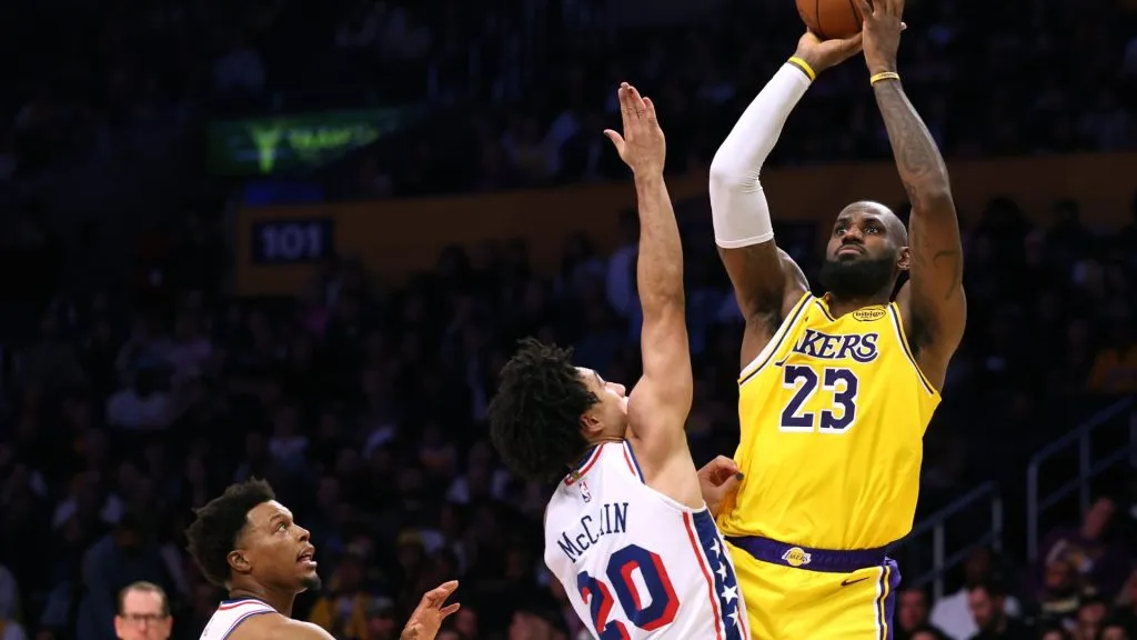 LeBron James #23 of the Los Angeles Lakers scores over Jared McCain #20 and Kyle Lowry #7 of the Philadelphia 76ers during a 116-106 Lakers winat Crypto.com Arena on November 08, 2024 in Los Angeles, California. (Photo by Harry How/Getty Images)