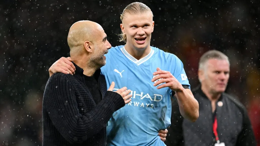 Pep Guardiola, Manager of Manchester City, and Erling Haaland interact after the team’s victory in the Premier League match between Manchester United and Manchester City. Michael Regan/Getty Images