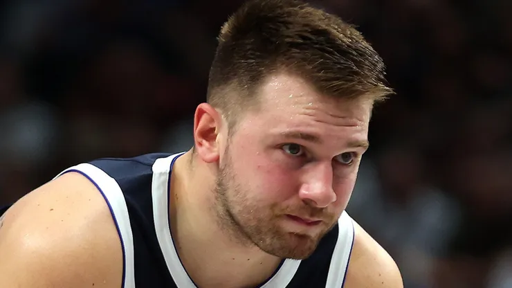 Luka Doncic #77 of the Dallas Mavericks holds his elbow after a fall on the court in the first half against the Houston Rockets at American Airlines Center on October 31, 2024 in Dallas, Texas.