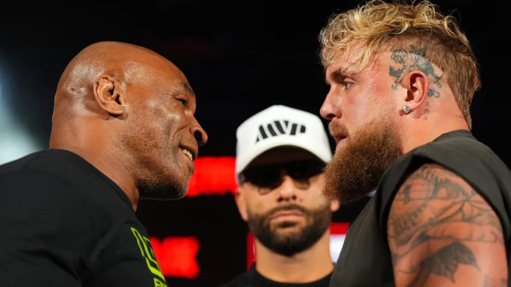 (L-R) Mike Tyson, Nakisa Bidarian and Jake Paul pose onstage during the Jake Paul vs. Mike Tyson Boxing match Arlington press conference at Texas Live! on May 16, 2024 in Arlington, Texas. (Photo by Cooper Neill/Getty Images for Netflix)