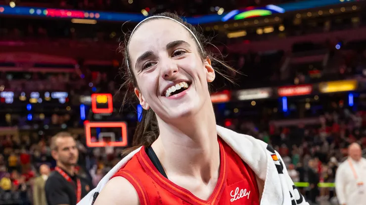 Caitlin Clark of Indiana Fever is presented the game ball after becoming the first rookie to score a triple double against the New York Liberty
