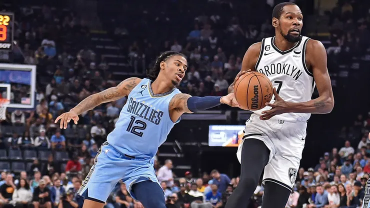 Kevin Durant #7 of the Brooklyn Nets goes to the basket against Ja Morant #12 of the Memphis Grizzlies during the game at FedExForum on October 24, 2022 in Memphis, Tennessee.