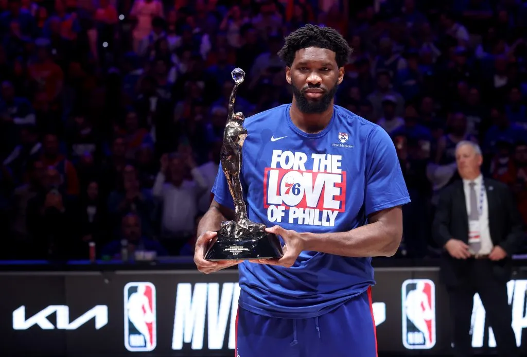 Joel Embiid #21 of the Philadelphia 76ers poses with the MVP trophy after being named 2022-23 Kia NBA Most Valuable Player. Tim Nwachukwu/Getty Images
