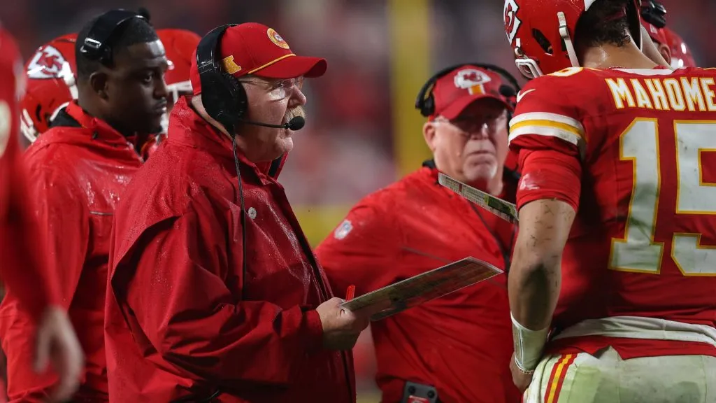 Head coach Andy Reid of the Kansas City Chiefs speaks to Patrick Mahomes #15 during overtime against the Tampa Bay Buccaneers at GEHA Field at Arrowhead Stadium on November 04, 2024 in Kansas City, Missouri.