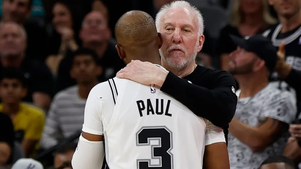 Chris Paul #3 of the San Antonio Spurs gets a hug from Head coach Gregg Popovich. Ronald Cortes/Getty Images