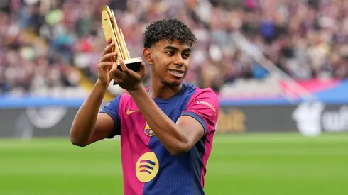 Lamine Yamal of FC Barcelona acknowledges the fans as he displays his 2024 Kopa Trophy prior to the La Liga EA Sports match between FC Barcelona and RCD Espanyol at Estadi Olimpic Lluis Companys on November 03, 2024 in Barcelona, Spain.