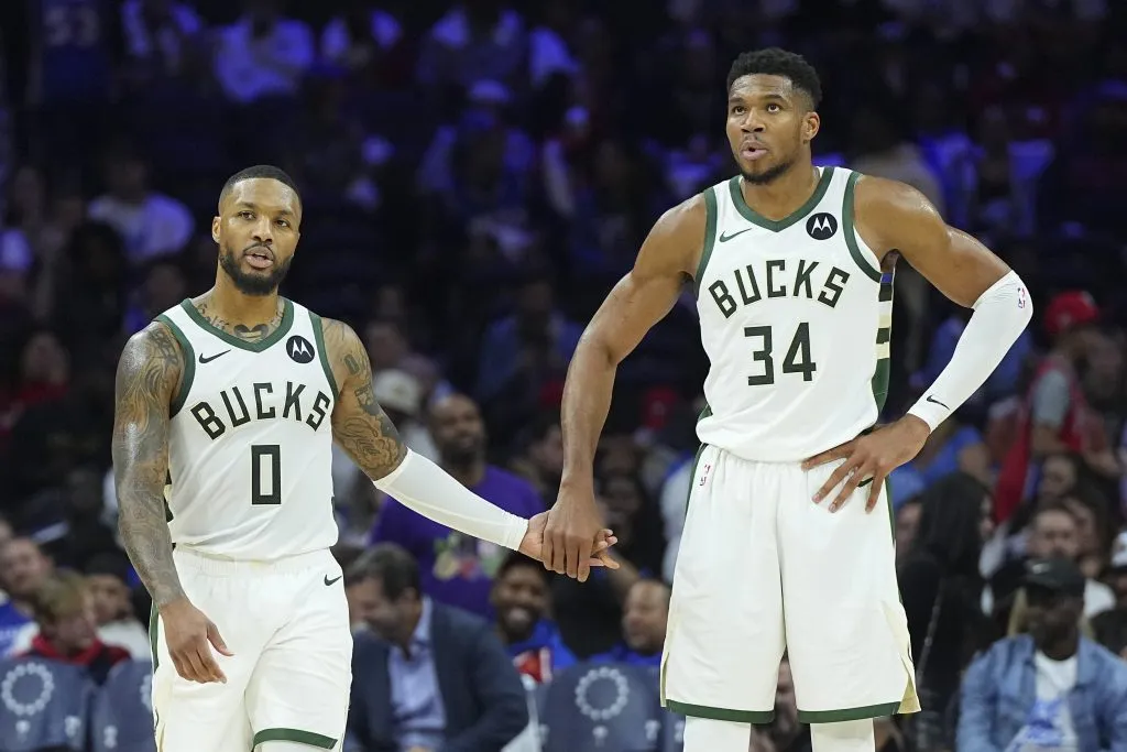 Damian Lillard #0 of the Milwaukee Bucks celebrates with Giannis Antetokounmpo #34 against the Philadelphia 76ers. Mitchell Leff/Getty Images