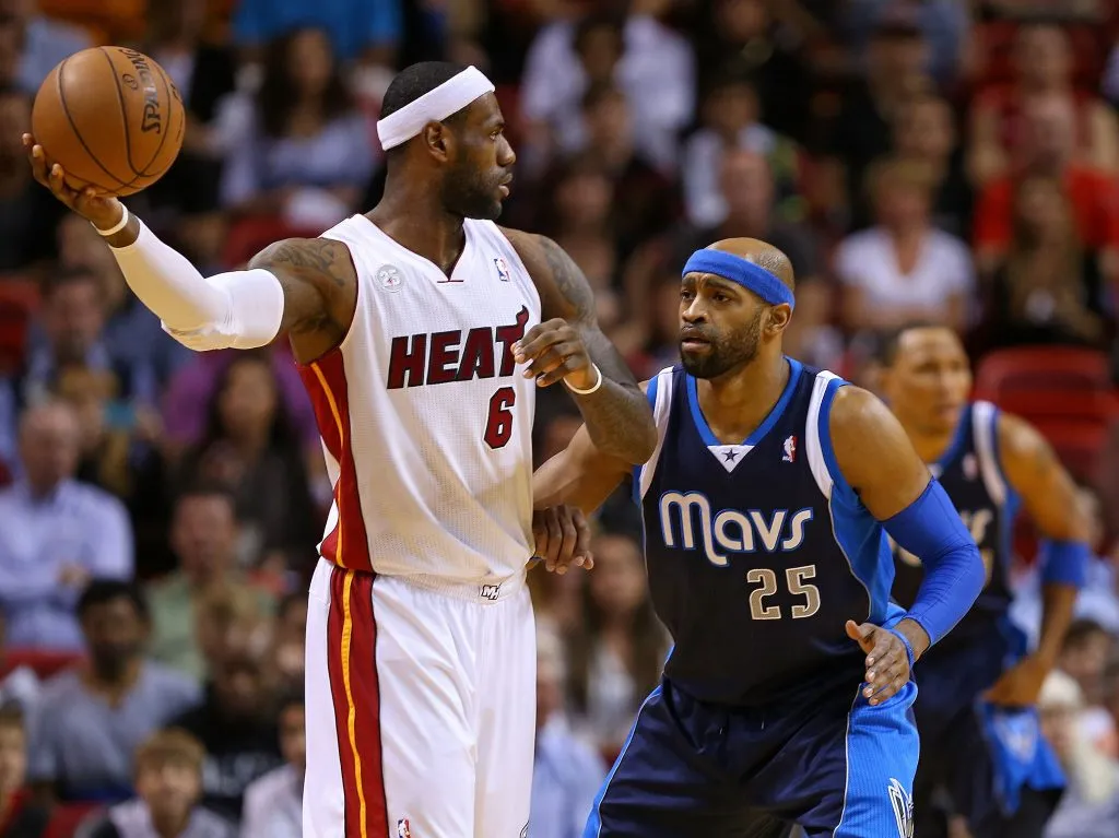 LeBron James #6 of the Miami Heat is defended by Vince Carter #25 of the Dallas Mavericks during a game at American Airlines Arena. Mike Ehrmann/Getty Images