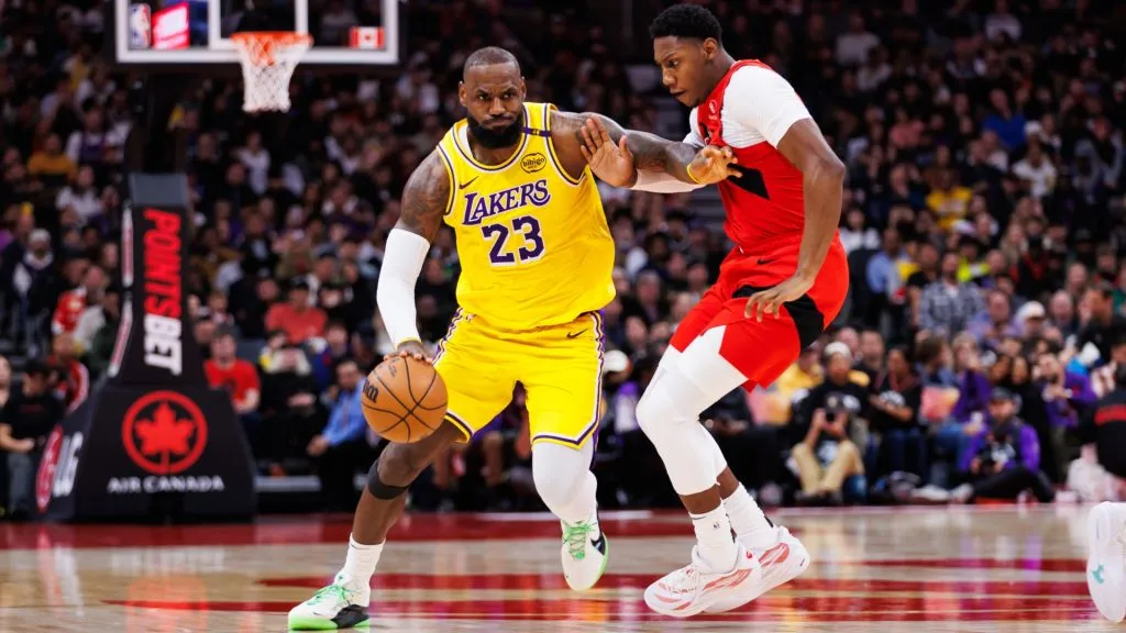 LeBron James #23 of the Los Angeles Lakers dribbles against RJ Barrett #9 of the Toronto Raptors during the first half of their NBA game at Scotiabank Arena on November 1, 2024 in Toronto, Canada. (Photo by Cole Burston/Getty Images)