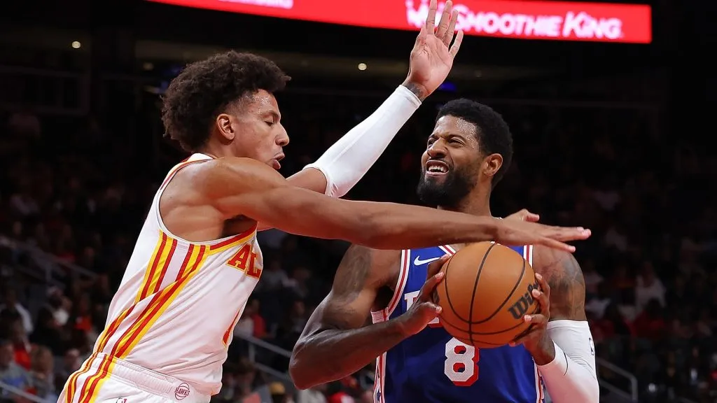 Paul George #8 of the Philadelphia 76ers draws a foul from Jalen Johnson #1 of the Atlanta Hawks during the second quarter at State Farm Arena on October 14, 2024 in Atlanta, Georgia. (Photo by Kevin C. Cox/Getty Images)