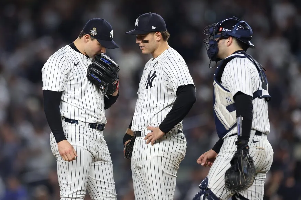 Tommy Kahnle #41 of the New York Yankees recieves a mound visit from Anthony Rizzo #48 and Austin Wells #28
