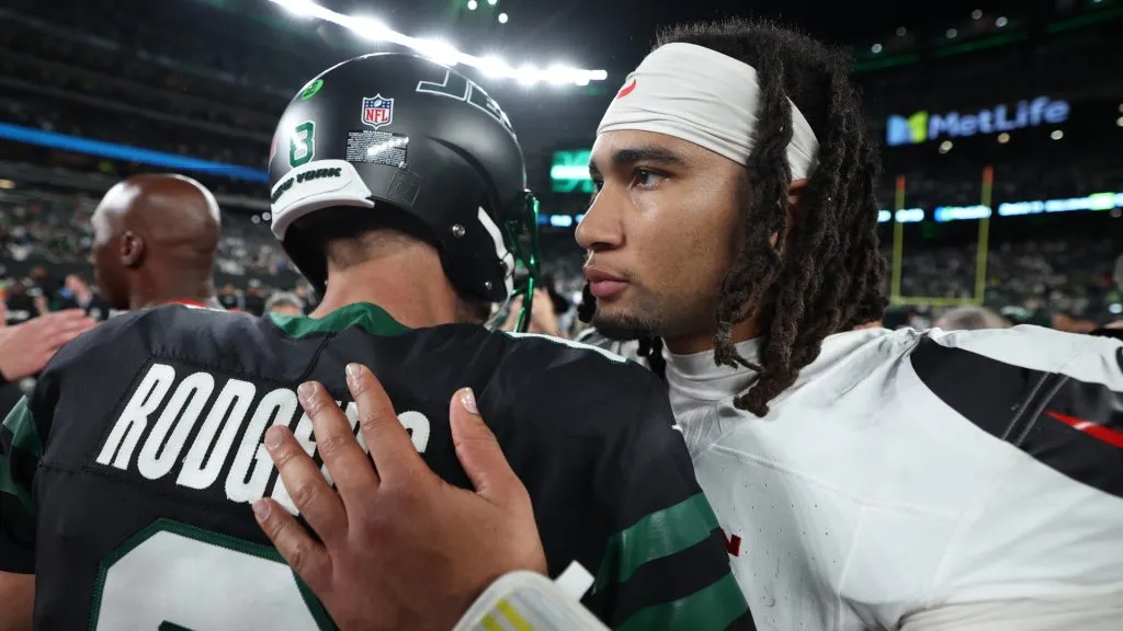 C.J. Stroud of the Houston Texans and Aaron Rodgers of the New York Jets embrace after the game at MetLife Stadium on October 31, 2024 in East Rutherford, New Jersey