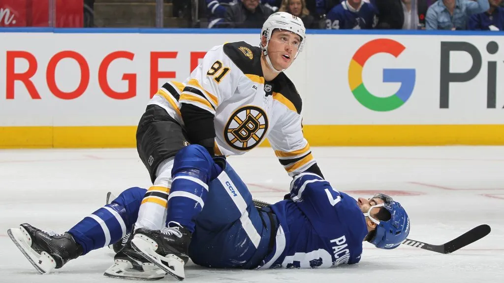 Nikita Zadorov #91 of the Boston Bruins takes down Max Pacioretty #67 ofthe Toronto Maple Leafs during the second period in an NHL game at Scotiabank Arena on November 5, 2024 in Toronto, Ontario, Canada.