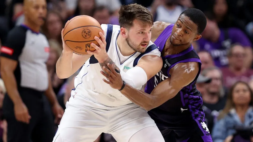 De'Aaron Fox #5 of the Sacramento Kings guards Luka Doncic #77 of the Dallas Mavericks in the first half at Golden 1 Center on March 26, 2024 in Sacramento, California.