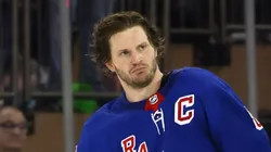 Jacob Trouba #8 of the New York Rangers is escorted off the ice following his second period fight with Dillon Dube #29 of the Calgary Flames at Madison Square Garden on February 06, 2023 in New York City.