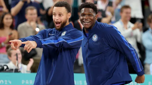 Gold medalists Stephen Curry and Anthony Edwards of Team United States react on the podium