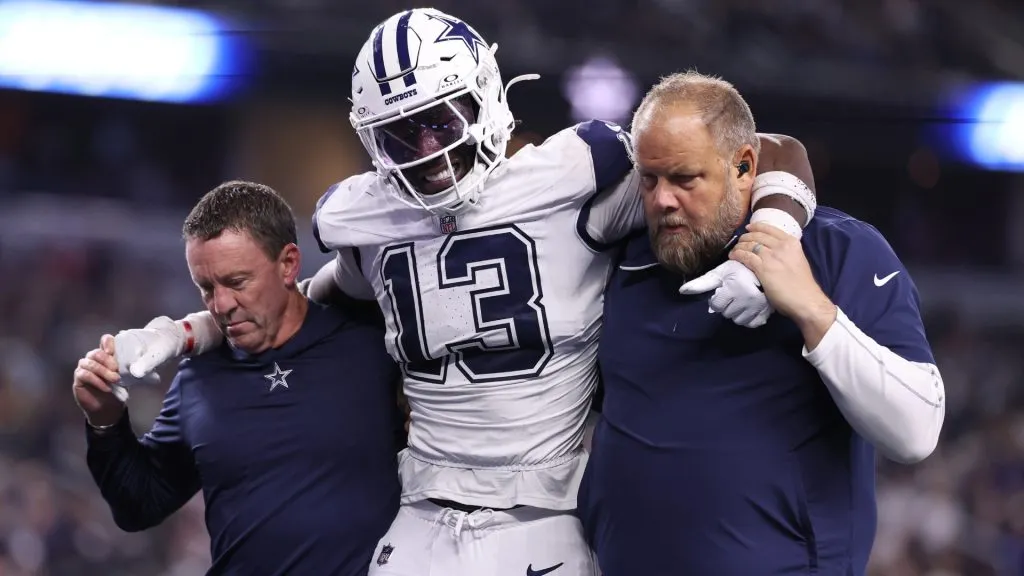DeMarvion Overshown #13 of the Dallas Cowboys is assisted off the field after a play against the Cincinnati Bengals during the fourth quarter in the game at AT&amp;T Stadium on December 09, 2024 in Arlington, Texas.