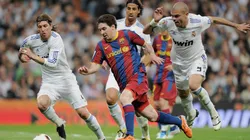 Lionel Messi from Barcelona dribbles the ball against Sergio Ramos, Sami Khedira and Pepe from Real Madrid.