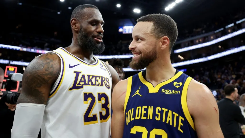 LeBron James #23 of the Los Angeles Lakers and Stephen Curry #30 of the Golden State Warriors talk to each other after the Lakers beat the Warriors in double overtime at Chase Center. (Ezra Shaw/Getty Images)