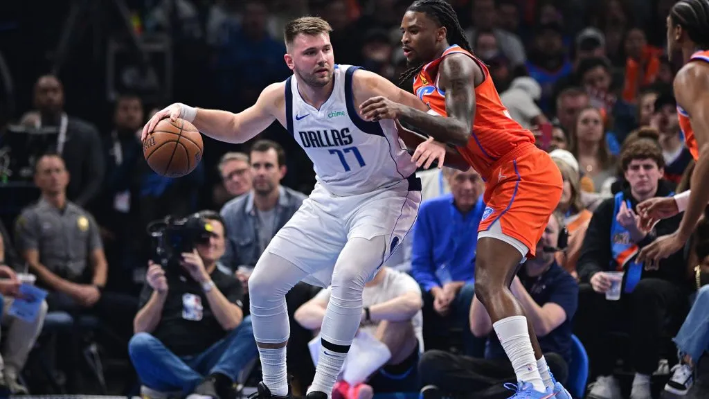 Luka Doncic #77 of the Dallas Mavericks handles the ball while being defended by Cason Wallace #22 of the Oklahoma City Thunder during the first half at Paycom Center. (Joshua Gateley/Getty Images)