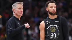 Golden State Warriors head coach Steve Kerr chats with guard Stephen Curry during a game vs. the Chicago Bulls on January 15, 2023.
