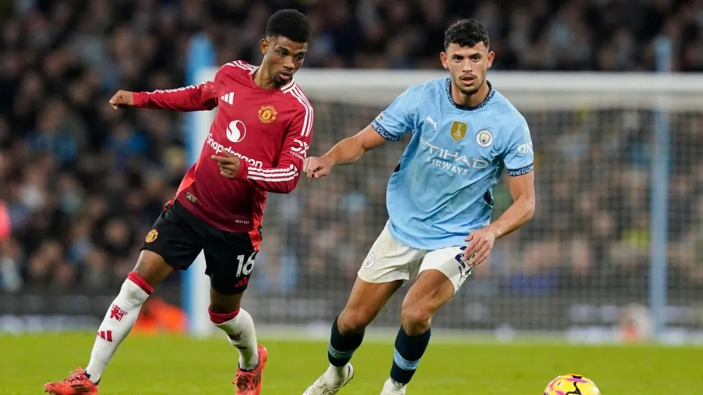 Amad Diallo of Manchester United, ManU trails Matheus Nunes of Manchester City during the Premier League match at the Etihad Stadium.