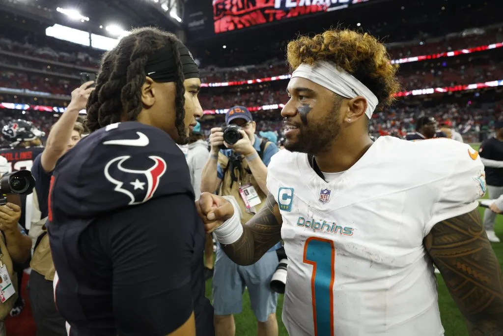 C.J. Stroud #7 of the Houston Texans talks to Tua Tagovailoa #1 of the Miami Dolphins
