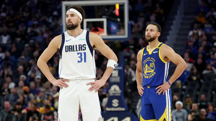 Klay Thompson #31 of the Dallas Mavericks and Stephen Curry #30 of the Golden State Warriors stand on the court in the first half at Chase Center.