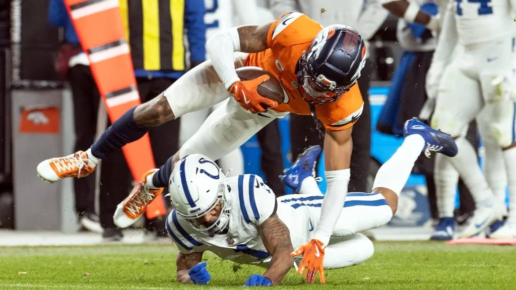 December 15, 2024, Denver, Colorado, USA: Broncos CB PAT SURTAIN II gets tackled hard by the Colts after an interception during the 2nd. Half at Empower Field at Mile High Sunday afternoon.The Broncos beat the Colts 31-13. Denver USA – ZUMAav4_ 20241215_zaf_av4_045 Copyright: xHectorxAcevedox