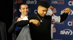 David Stearns, the president of baseball operations for the New York Mets fits Juan Soto with his New York Mets jersey during his introductory press conference at Citi Field on December 12, 2024 in New York City.