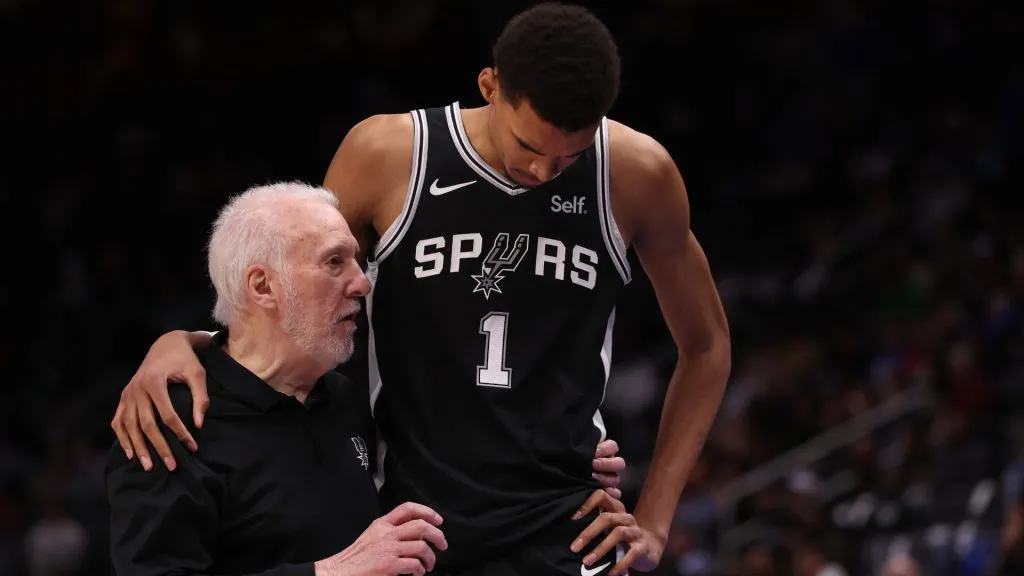Head coach Gregg Popovich of the San Antonio Spurs talks to Victor Wembanyama #1 during the second half while playing the Detroit Pistons at Little Caesars Arena. (Gregory Shamus/Getty Images)