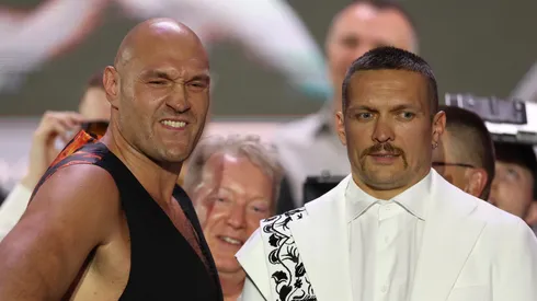 Tyson Fury reacts alongside Oleksandr Usyk ahead of the IBF, IBO, WBA, WBC and WBO