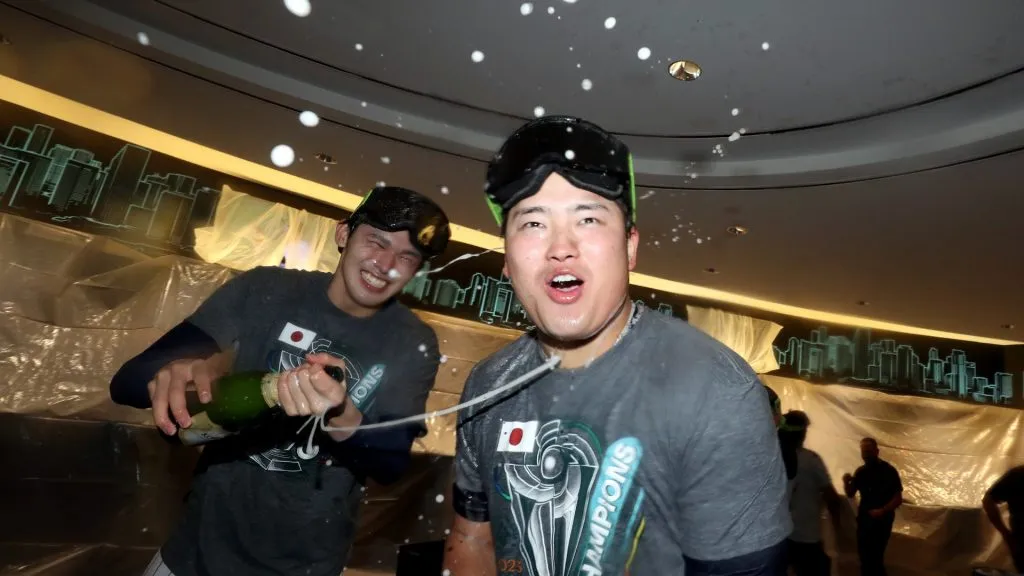 Masataka Yoshida #34 and Roki Sasaki #14 of Team Japan celebrate in the clubhouse after defeating Team USA in the World Baseball Classic Championship 3-2 at loanDepot park on March 21, 2023 in Miami, Florida. (Photo by Alex Trautwig/Getty Images)