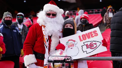 A Kansas City Chiefs fan, dressed as Santa Claus, poses for a photo with a fan before their game against the Seattle Seahawks.