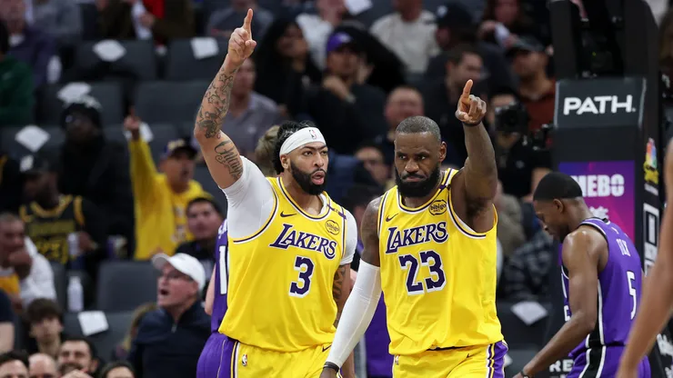 Anthony Davis #3 and LeBron James #23 of the Los Angeles Lakers point down court after a turnover in their game against the Sacramento Kings.