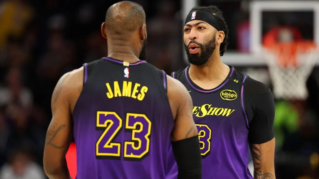 LeBron James #23 of the Los Angeles Lakers interacts with Anthony Davis #3 prior to the start of the first quarter against the Minnesota Timberwolves at Target Center. (David Berding/Getty Images)