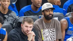 Dallas Mavericks Luka Doncic 77 and Kyrie Irving 11 watch from the bench during an NBA