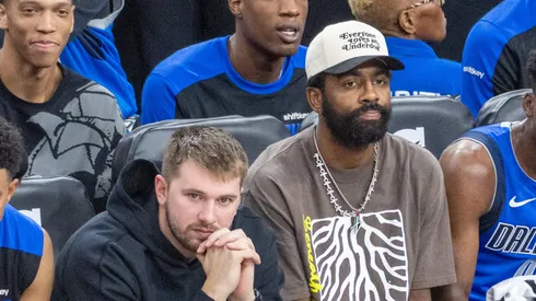 Dallas Mavericks Luka Doncic 77 and Kyrie Irving 11 watch from the bench during an NBA