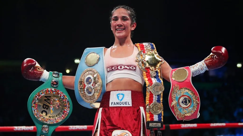 Amanda Serrano celebrates with the WBO, WBC, IBF & IBO World Featherweight Championship belts after defeating Sarah Mahfoud in the WBO, WBC, IBF & IBO World Featherweight Championship fight. (Source: Alex Livesey/Getty Images)