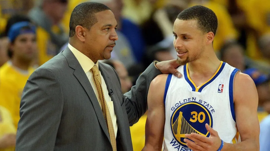 Golden State Warriors Stephen Curry (30) talks with coach MARK JACKSON during a Western Conference playoff game.