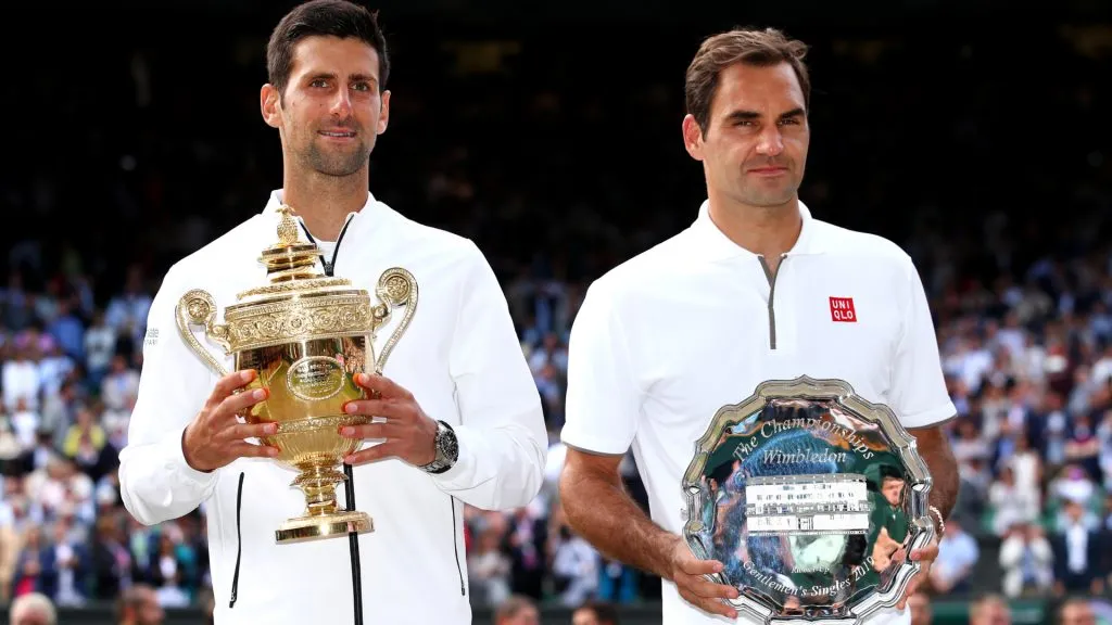 Novak Djokovic of Serbia and Roger Federer of Switzerland pose for a photo with their trophies after 2019 Wimbledon final. (Clive Brunskill/Getty Images)