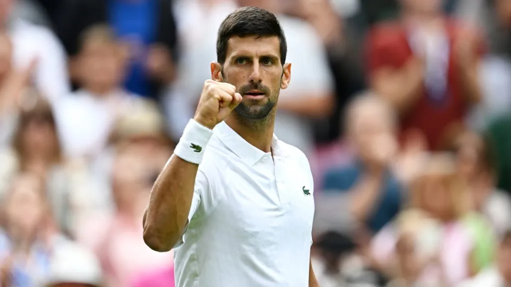 Novak Djokovic celebrates winning match point against Pedro Cachin of Argentina in the Men’s Singles first round match on day one of The Championships Wimbledon 2023. (Source: Shaun Botterill/Getty Images)