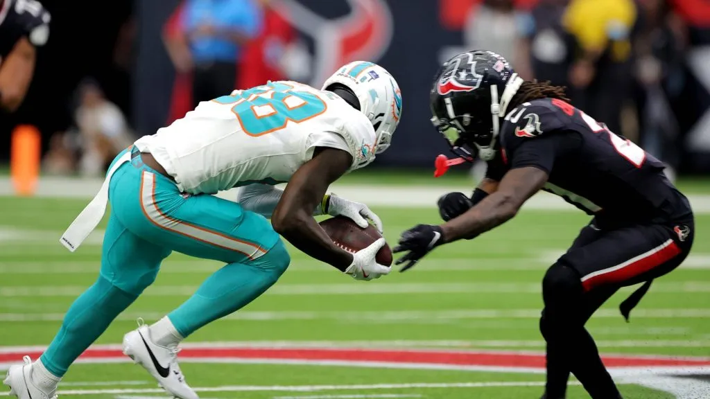 Miami Dolphins wide receiver Grant DuBose (88) is tackled by Houston Texans safety Calen Bullock (21).