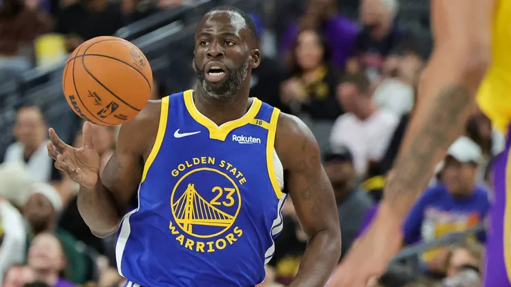 Draymond Green #23 of the Golden State Warriors brings the ball up the court against the Los Angeles Lakers in the first quarter of their preseason game.