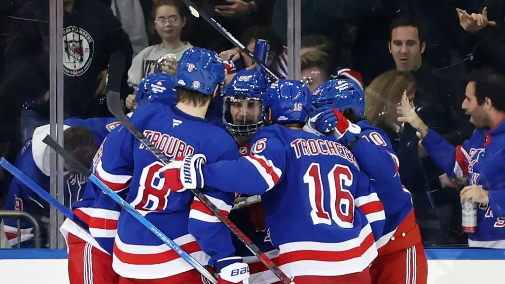 The New York Rangers celebrate a goal scored by Ryan Lindgren #55