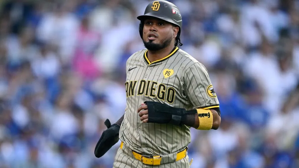 Luis Arraez #4 of the San Diego Padres celebrates after scoring a run during the first inning against the Los Angeles Dodgers in Game One of the Division Series at Dodger Stadium on October 05, 2024 in Los Angeles, California. (Photo by Orlando Ramirez/Getty Images)