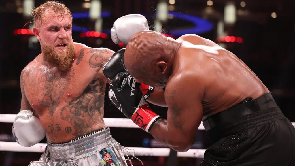 Jake Paul punches Mike Tyson during LIVE On Netflix: Jake Paul vs. Mike Tyson at AT&amp;T Stadium on November 15, 2024 in Arlington, Texas. (Photo by Al Bello/Getty Images for Netflix © 2024)